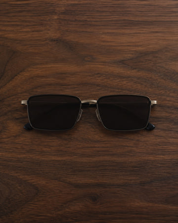 Dark rectangular sunglasses centred on dark walnut